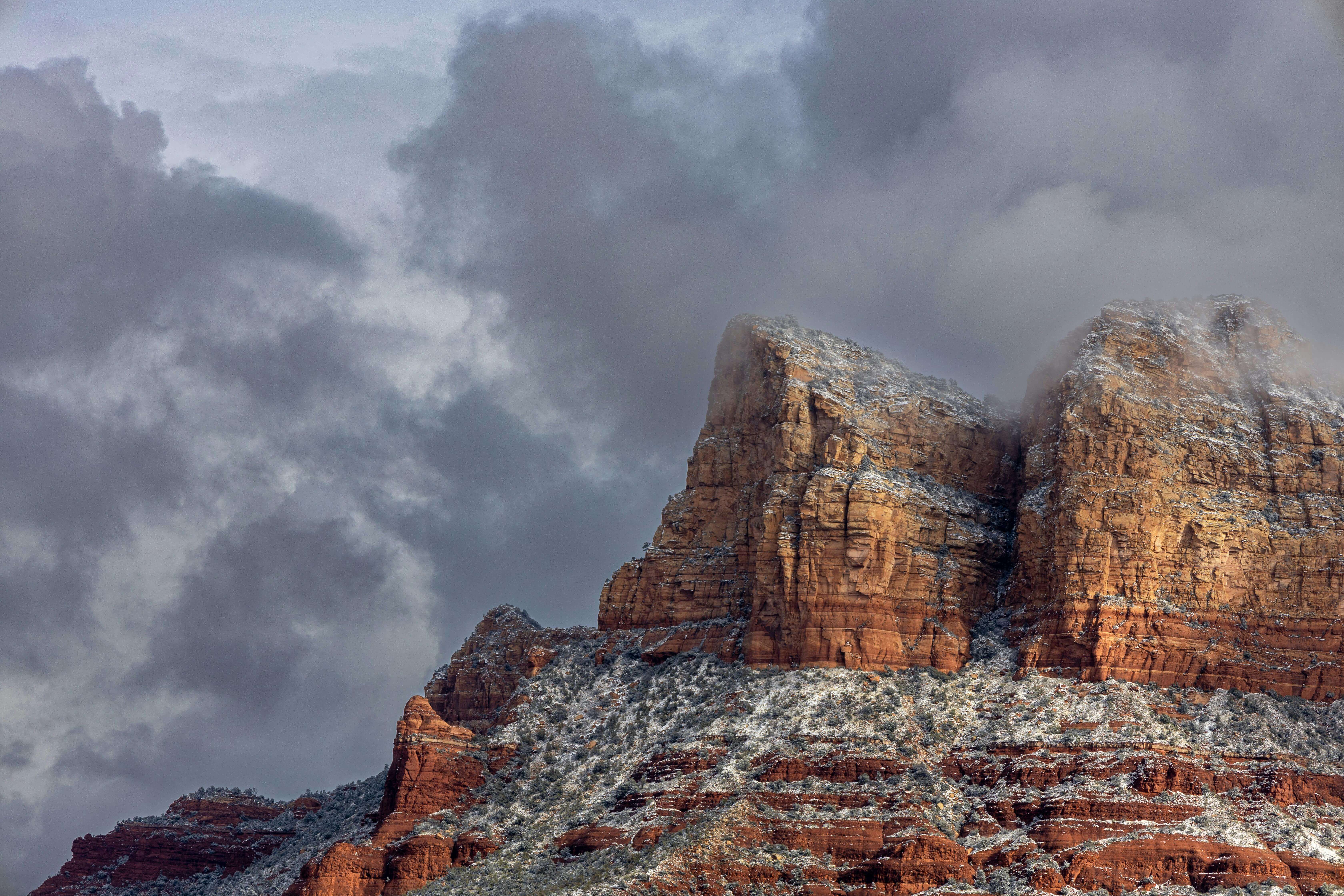 Tall red rock formations rising over the desert floor in Sedona